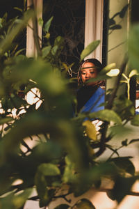 Portrait of young woman sitting outdoors