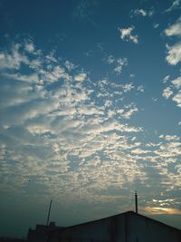 Low angle view of silhouette building against sky