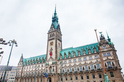 Low angle view of clock tower against sky