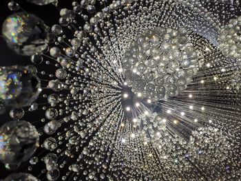 Low angle view of illuminated chandelier hanging on ceiling