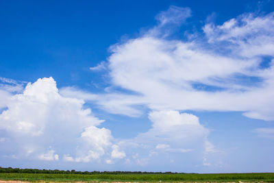 Scenic view of land against blue sky