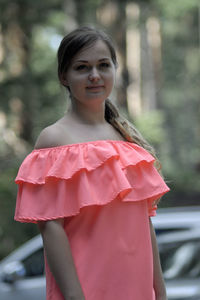 Portrait of smiling girl standing against trees
