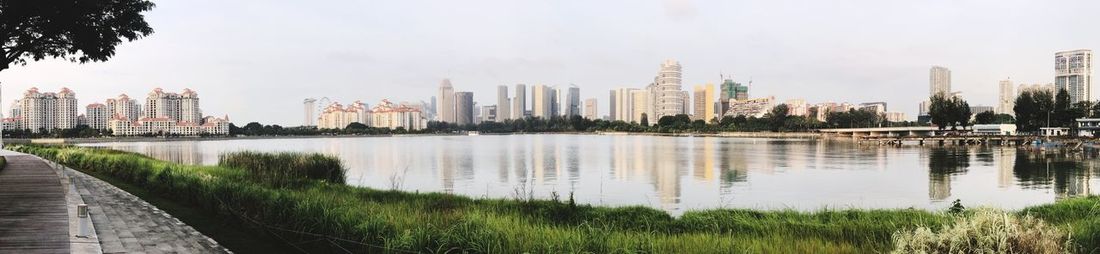 Panoramic view of lake by buildings against sky