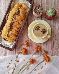 Banana strudel and a cup of cappucino on a table