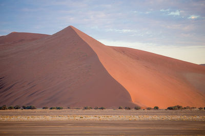 View of desert against cloudy sky