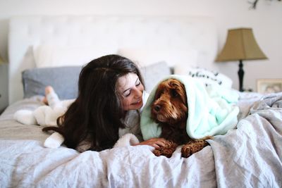 Dogs relaxing on bed at home