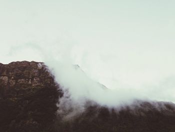 Scenic view of mountains against cloudy sky