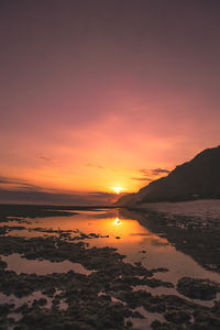 Scenic view of sea against romantic sky at sunset