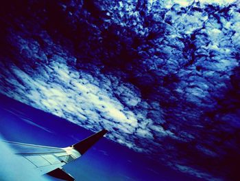 Low angle view of airplane flying in sky