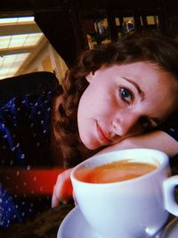 Portrait of woman having coffee at table