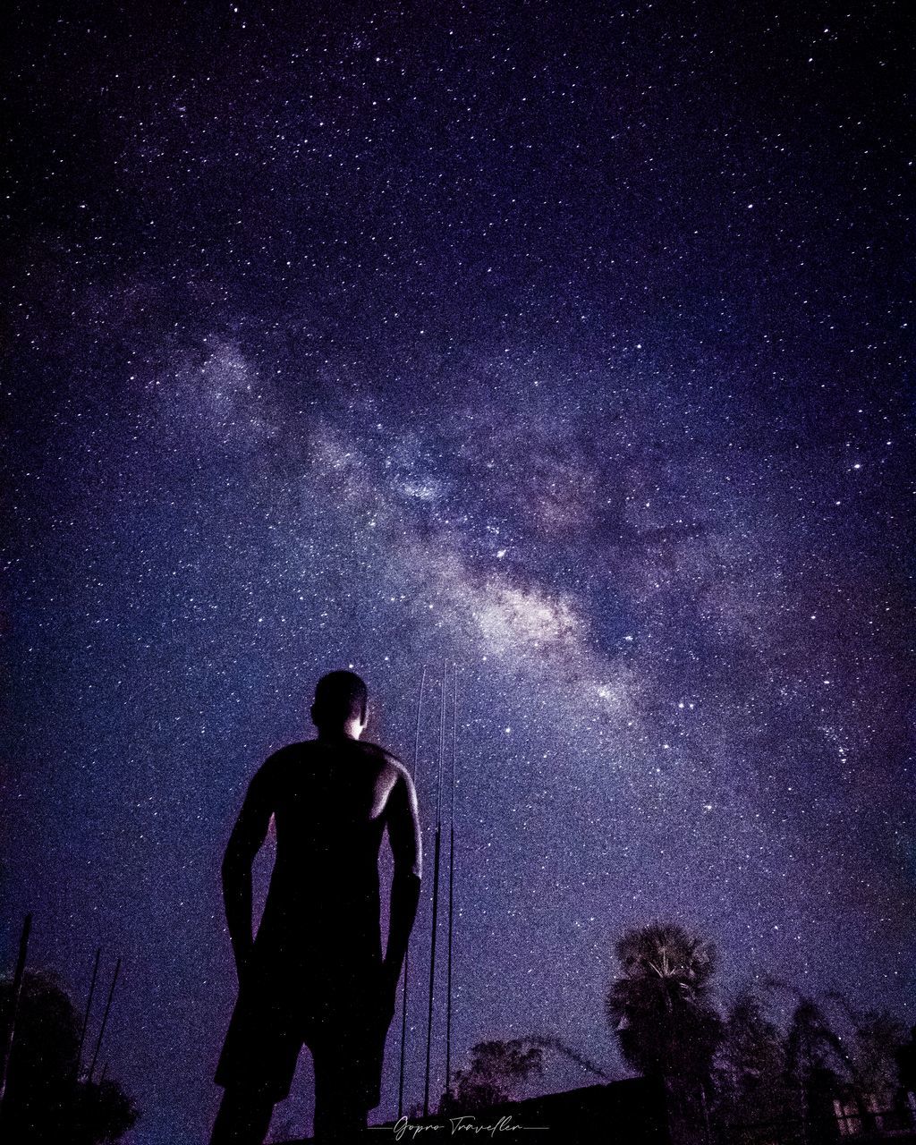 SILHOUETTE MAN STANDING AGAINST STAR FIELD AGAINST SKY