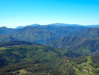 Scenic view of mountains against clear blue sky