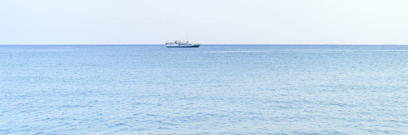 Sailboat sailing on sea against clear sky