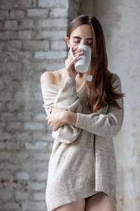 Young woman drinking coffee cup