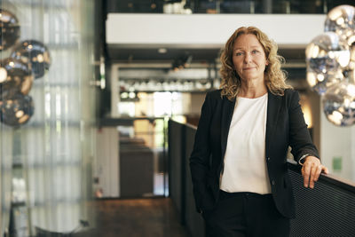 Portrait of young woman standing in supermarket