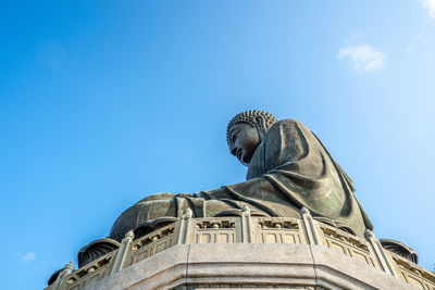 Low angle view of statue against blue sky