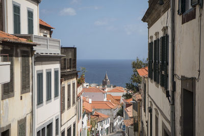 High angle view of buildings by sea against sky