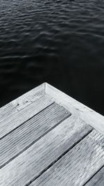 Close-up of pier by river