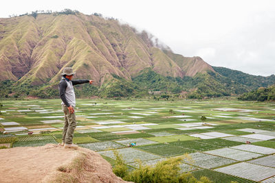 Rear view of man standing on mountain