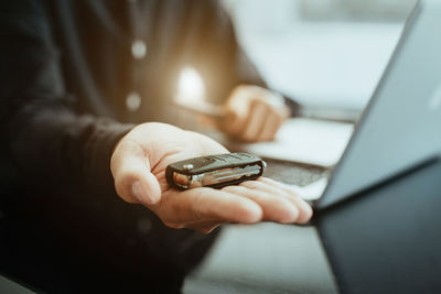 Midsection of woman using mobile phone