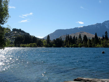 Scenic view of sea and mountains against sky