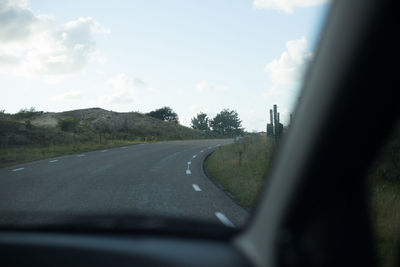 Empty road along countryside landscape