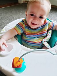 Portrait of cute baby boy playing with toy