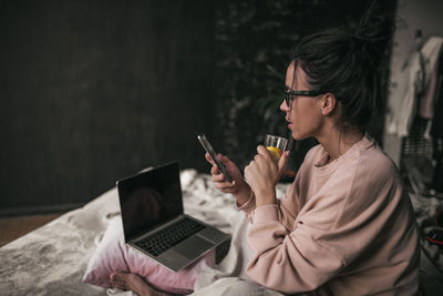 Midsection of man using mobile phone