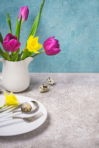 Close-up of multi colored tulips in vase on table