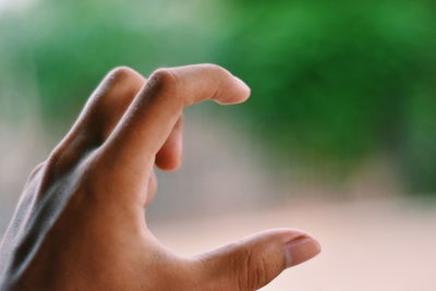 Close-up of person hand against blurred background