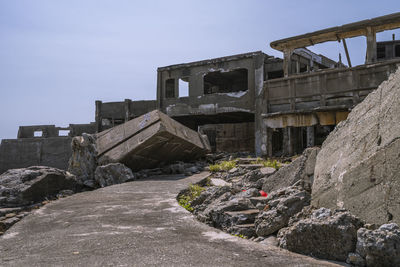 Low angle view of abandoned building against sky