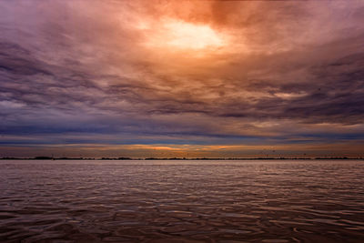 Scenic view of sea against dramatic sky