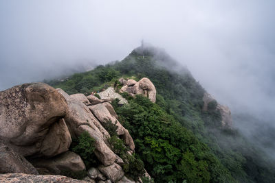 Scenic view of mountains in foggy weather