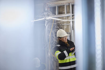 Female engineer using digital tablet at building site