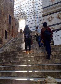 Low angle view of people walking on steps