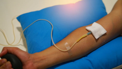 Cropped hand of patient with iv drip