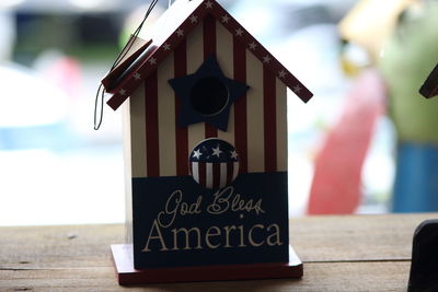 Close-up of sign board on table