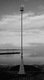 Pole on beach against sky