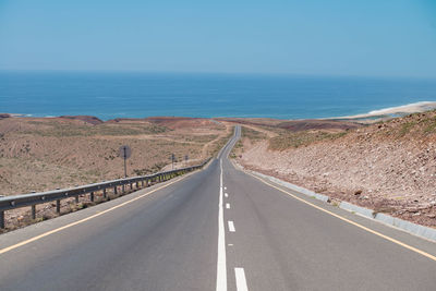 Road by sea against sky