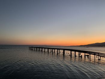 Scenic view of sea against clear sky during sunset