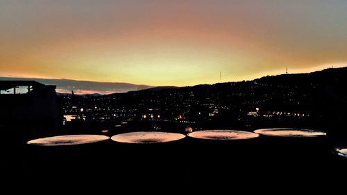 Silhouette of buildings against sky during sunset