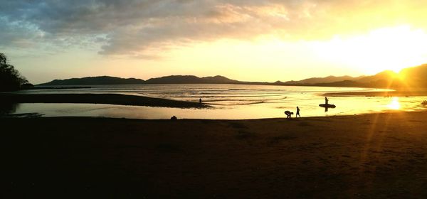 Scenic view of beach against sky during sunset