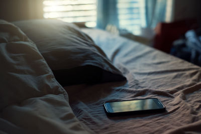 Smart phone on bed at home