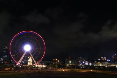 Illuminated ferris wheel at night