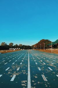 Surface level of road against blue sky