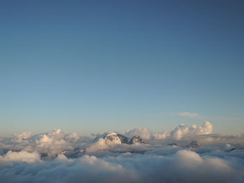 Low angle view of clouds over mountain