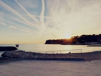 Scenic view of beach against sky during sunset