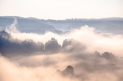 Scenic view of mountains against cloudy sky