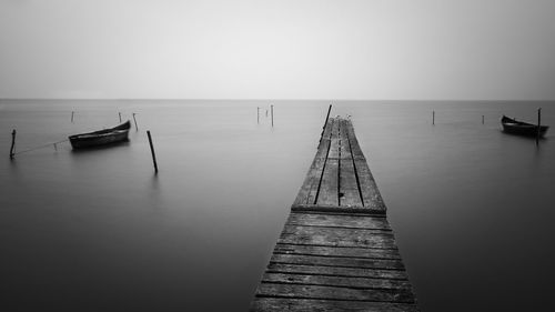 Pier on sea against sky