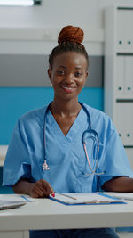 Portrait of smiling female doctor working in office